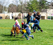 Kids searching for Easter eggs with buckets in their hands at a previous Reston Community Center egg hunt.
