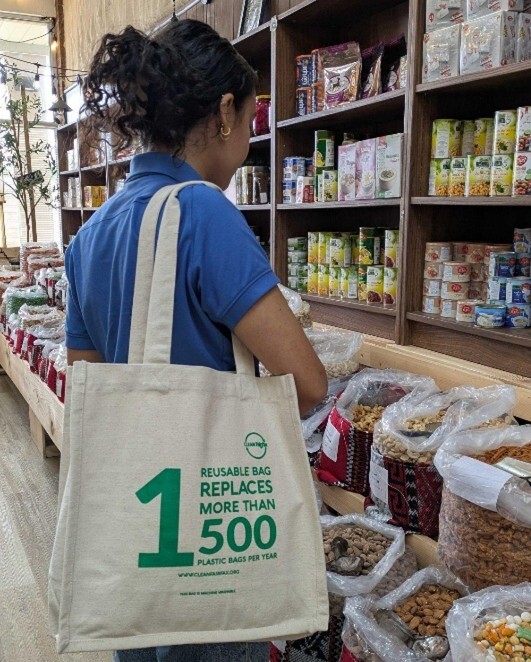 woman in store with canvas on shoulder.