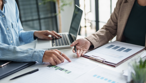 People sitting at a table reviewing tax documents.