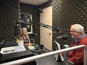 man and woman talking during podcast