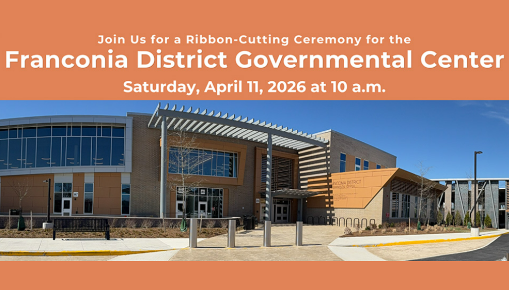 Outside of the new Franconia District Governmental Center with the text "Join us for a ribbon-cutting ceremony on April 11 at 10 a.m."