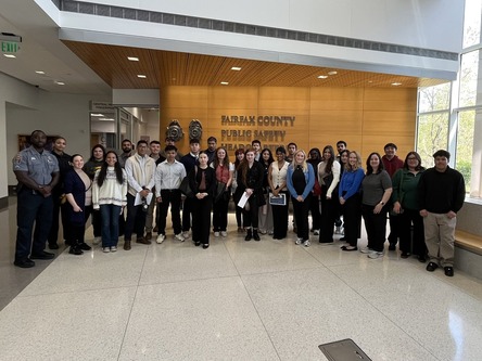 George Mason University students smile with Fairfax County police officers. 