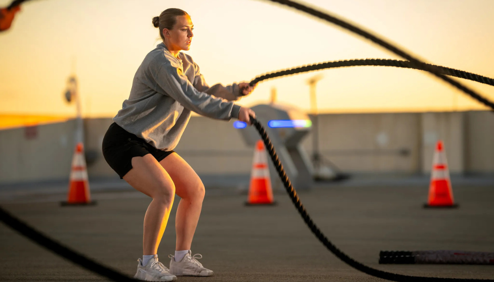 A PARS participant exercises by doing battle ropes. 