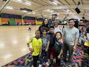 Group of adults and children at roller rink