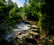 A stone trail over a river.