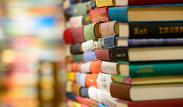 Stack of books with multicolored spines.