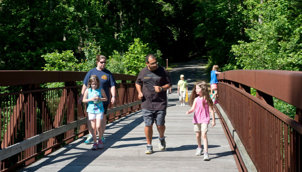 A family walks on a Park Authority trail.