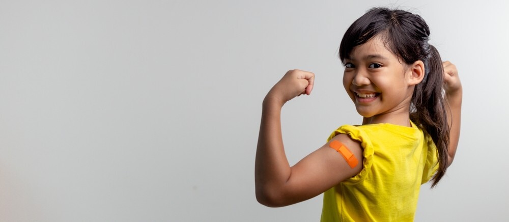 Girl with band aid on upper arm