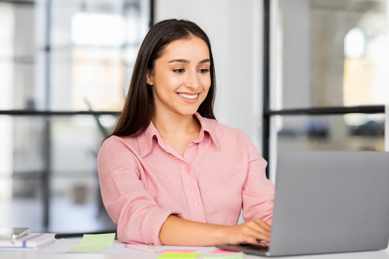 smiling woman using laptop computer