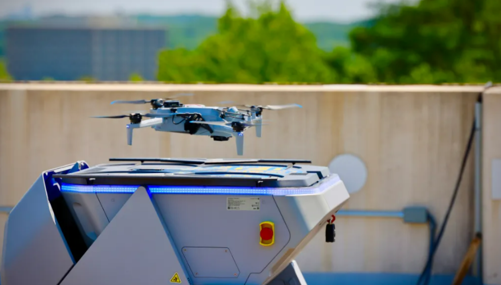 A drone hovering above a landing pad. 
