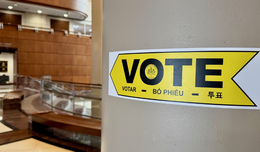 Vote sticker pointing in the direction to vote at the Fairfax County Government Center.