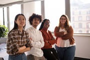 four teens smiling in classroom