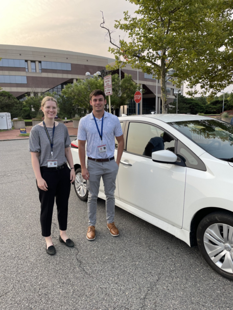 two people posing by a car with a temperature sensor attached