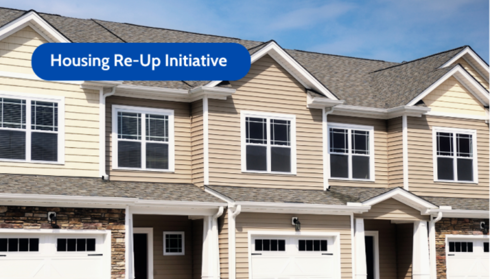 A neighborhood of single family homes with the text "Housing Re-Up Initiative." 