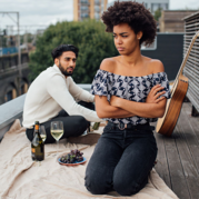 woman sitting on the floor looking away from men