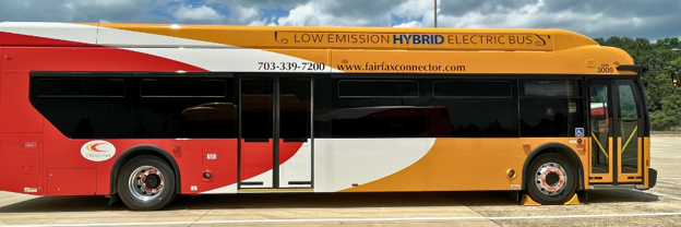 A low‑emission hybrid electric bus with a red, white, and yellow design parked outdoors.