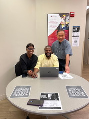 tabling event with three adults