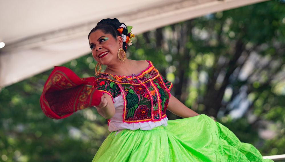 A dancer with the Corazón Folklórico Dance Company wears traditional Mexican wear.