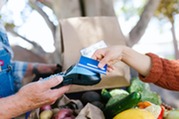 person using card at farmers market