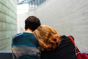 woman resting her head on another person's shoulder