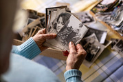 woman looking at old family photos
