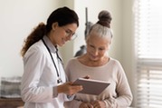 two women looking at a device