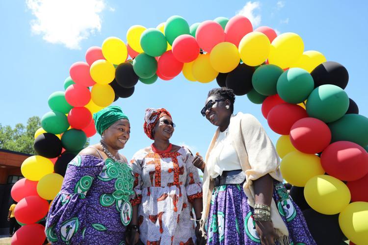 Three African American women in front of a balloon arch for Juneteenth