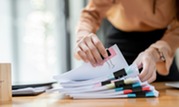 Person's hands sorting through documents