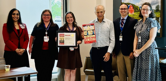 Photo of Encompass Health Rehab staff receiving reward for becoming a Stroke Smart partner