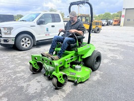 Public Works crew member test-drives an electric mower
