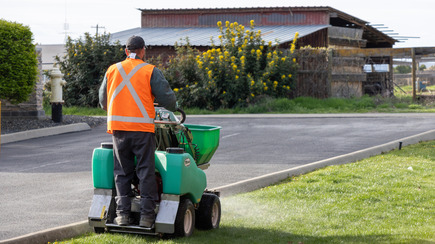 licensed applicator treating a yard for Japanese beetle 