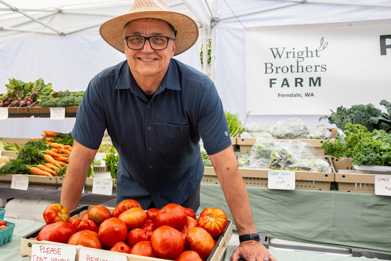 farmer with tomatoes at market 
