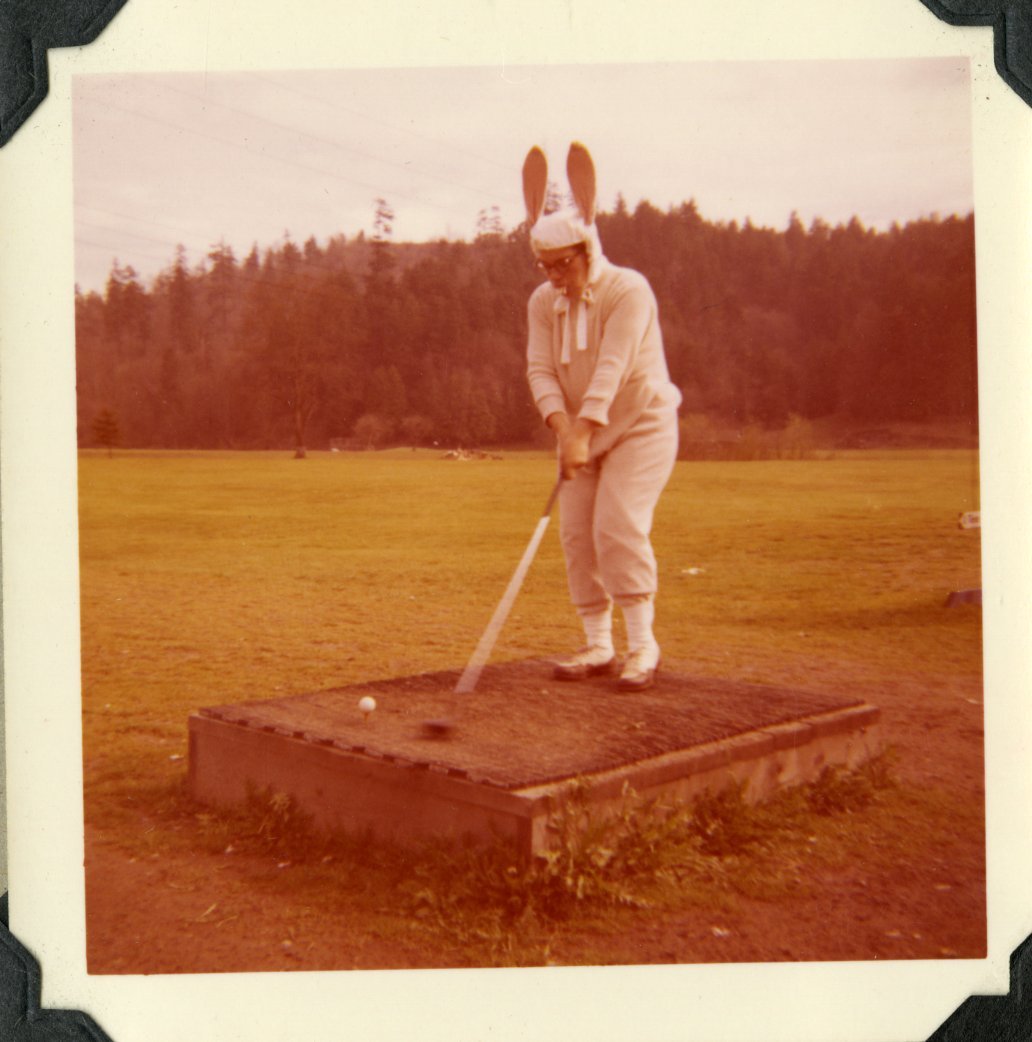 An old photograph of a woman playing golf in a bunny rabbit costume