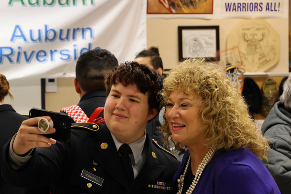 An Auburn School District JROTC cadet and Mayor Nancy Backus