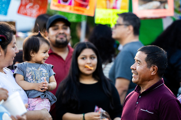 A grandpa and a child smiling at each other 