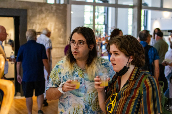 a couple at postmark checking out some cool art