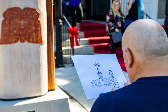 a man drawing the Postmark Center for the Arts