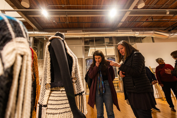 A pair of women admiring a piece of artwork