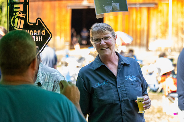 A woman enjoying a brewskie at Hops n' Crops