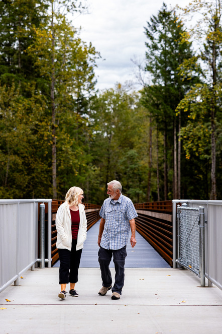 A couple walking across the Game Farm Park Bridge