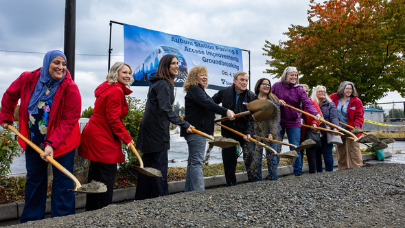 Auburn councilmembers, Sound Transit leadership, King County councilmembers and Mayor Nancy Backus throwing dirt from a shovel