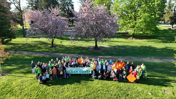 A buncha people holding a banner that says Clean Sweep