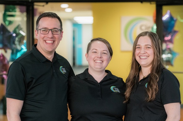 Three people smiling at the camera