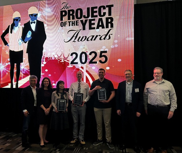 Auburn Public Works team poses with their 2025 Project of the Year awards on stage.