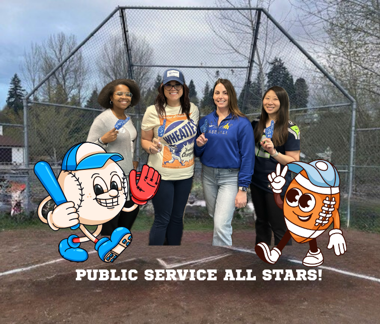 Four women pose on a baseball field holding foam fingers, joined by cartoon baseball and football characters.