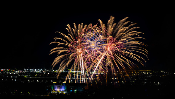 Emerald Downs pictured at night with large firework blooms above it
