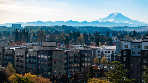 An aerial photo of downtown Auburn showing apartment buildings and Mount Rainier in the background.