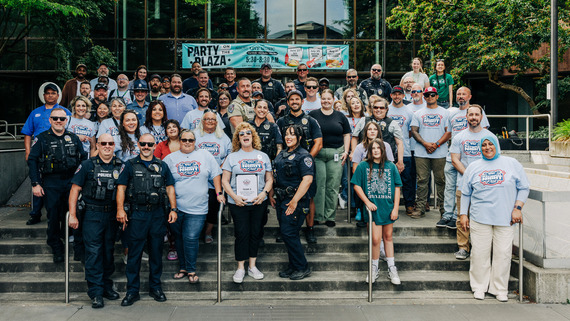 A large crowd of people standing on a staircase for National Night Out