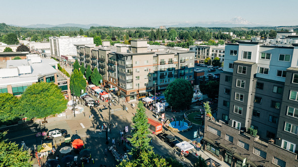 Aerial view of downtown Auburn street fair with Mount Rainier in distance.