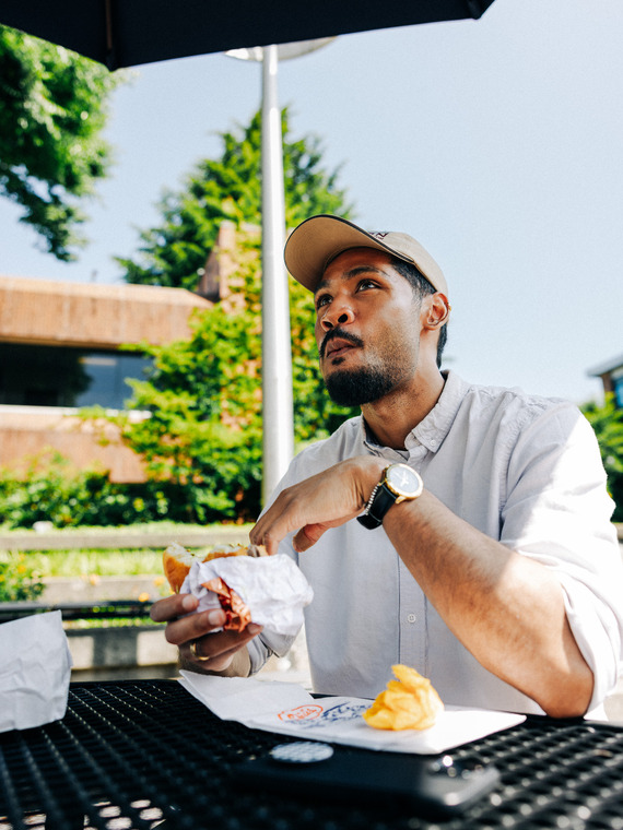 A smiling man eating a delicious meal 